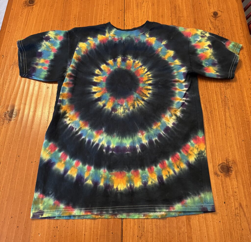 Shirt with alternating rings of black with rings of rainbow colors