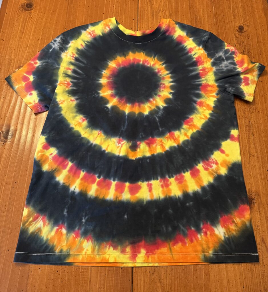 Shirt with alternating rings of black with rings of red, orange, and yellow