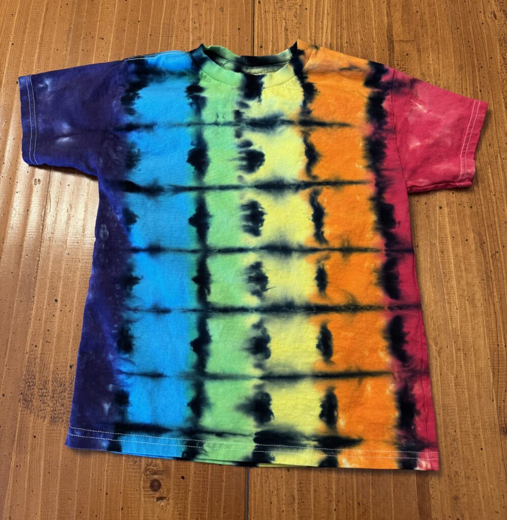 Shirt with stripes of rainbow colors, separated into squares with black lines